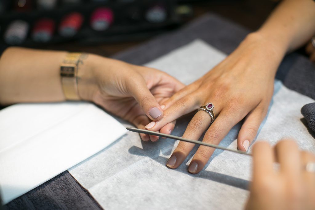 Filing nails women's manicure