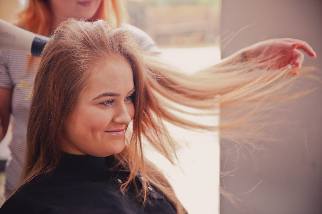 girl at salon getting a blow dry on her hair